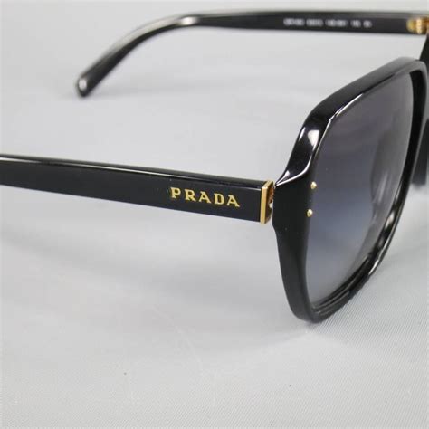 prada black and gold sunglasses.